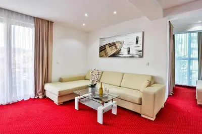 a living room with a couch and a table at Hotel La mer in Budva