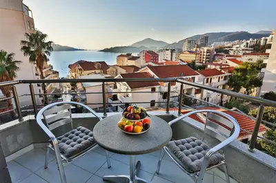 a bowl of fruit on a table on a balcony at Hotel La mer in Budva