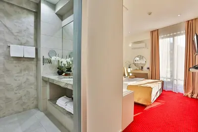 a hotel room with a bed and a bathroom at Hotel La mer in Budva