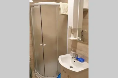 a bathroom with a shower and a sink at Lucia's Apartment in Sutomore