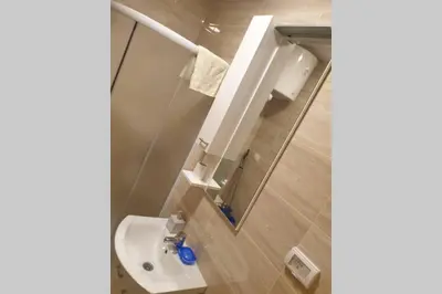 a bathroom with a toilet and a sink and a mirror at Lucia's Apartment in Sutomore
