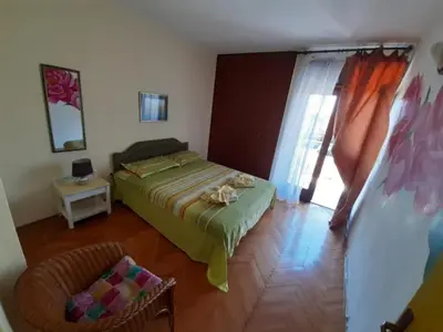 a bedroom with a bed and a window at Two bedroom ap in the garden in Buljarica