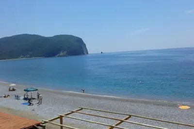 a group of people on a beach near the water at Two bedroom ap in the garden in Buljarica
