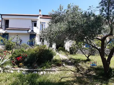 a house with a garden in front of it at Two bedroom ap in the garden in Buljarica