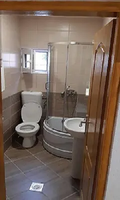 a bathroom with a toilet and a tub and a sink at Apartment Sali in Kotor