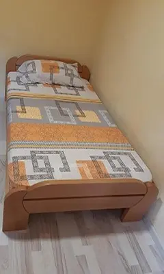 a bed sitting in the corner of a room at Apartment Sali in Kotor