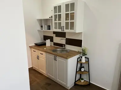 a kitchen with white cabinets and a sink at Studio apartment Vukcevic 2 in Podgorica