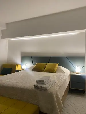 a bedroom with a bed with towels on it at Seafront Apartments in Ulcinj