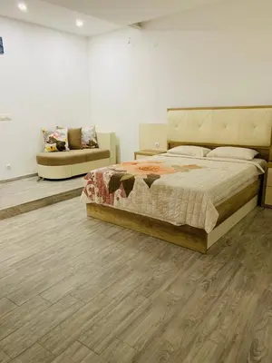 a bedroom with a large bed and a couch at Seafront Apartments in Ulcinj