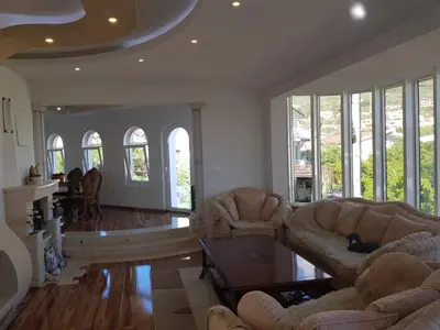 a living room with two couches and a table at Guest house Nina in Bar