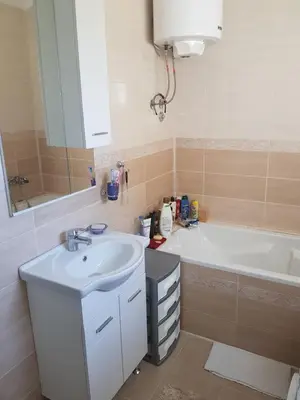 a bathroom with a sink and a bath tub at Guest house Nina in Bar