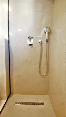 a shower stall with a shower head and a shower at Kala Rooms & Suites in Budva