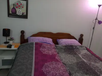 a bedroom with a bed with a quilt on it at Apartman Savić in Bar