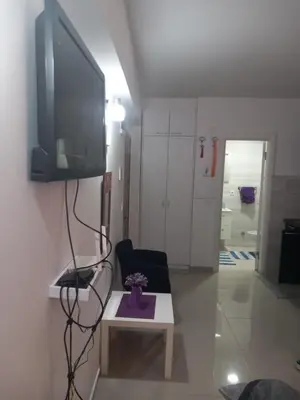 a living room with a tv on a wall at Apartman Savić in Bar