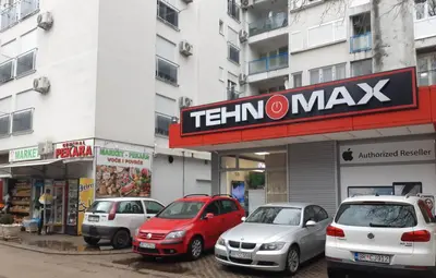 a group of cars parked in front of a building at Apartman Savić in Bar