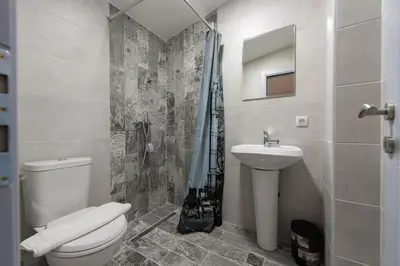 a bathroom with a toilet and a sink and a shower at Studio Apartments Bulevar in Podgorica