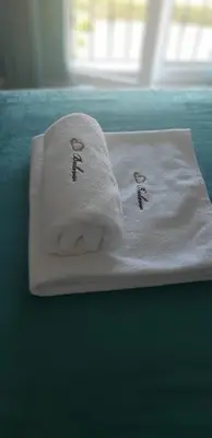 a stack of towels sitting on top of a bed at Studio Apartments Bulevar in Podgorica