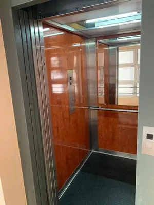 a glass door of a elevator in a building at Sunny Apartment Petrovac in Petrovac na Moru