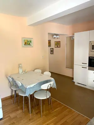 a kitchen and dining room with a table and chairs at Sunny Apartment Petrovac in Petrovac na Moru