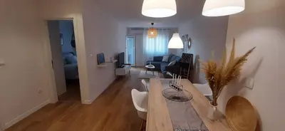 a living room with a dining table and a living room at Lux Apartment PortoVista in Bar