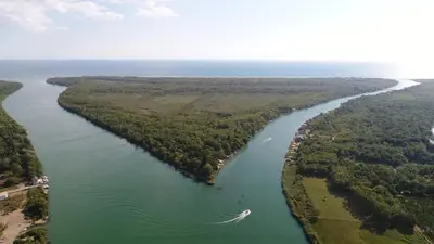 an aerial view of a river with a boat in it at METROPOLIS in Ulcinj