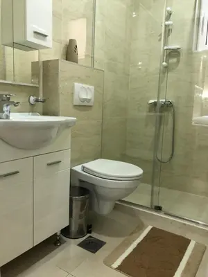 a bathroom with a toilet and a sink and a shower at METROPOLIS in Ulcinj