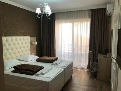 a bedroom with two beds and a large window at METROPOLIS in Ulcinj
