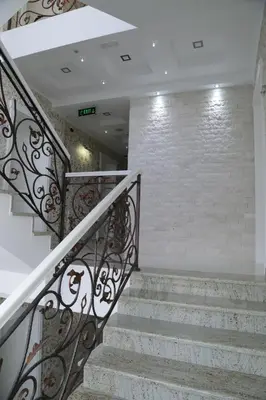 a set of stairs with a wrought iron railing at METROPOLIS in Ulcinj