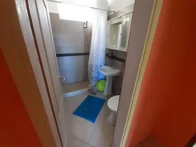 a small bathroom with a toilet and a sink at Family apartment Garden and Sea in Petrovac na Moru