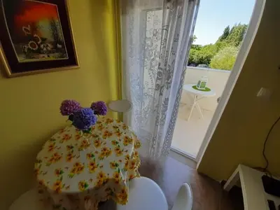 a cake with flowers on it sitting on a table in a room at Family apartment Garden and Sea in Petrovac na Moru