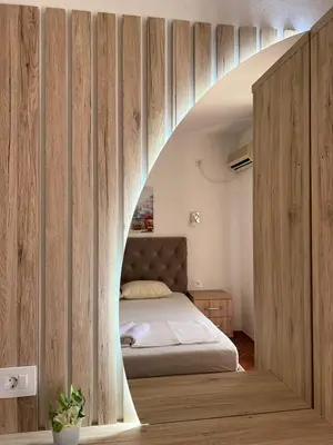 a bedroom with a bed with an archway at Kontiki Apartments in Ulcinj