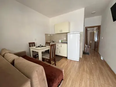 a living room with a couch and a kitchen at Kontiki Apartments in Ulcinj