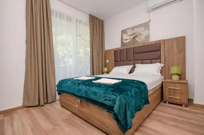 a bedroom with a large bed and a window at L’odore Del Mare in Sutomore