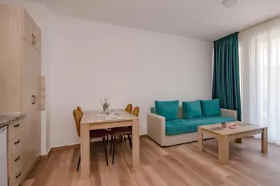 a living room with a couch and a table at L’odore Del Mare in Sutomore
