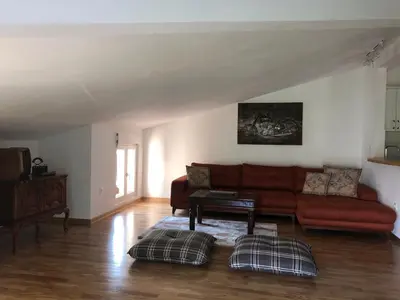 a living room with a couch and two pillows at Green Silence - Anja in Danilovgrad