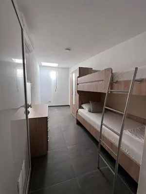 a room with two bunk beds and a desk at Hotel MonteNino in Bar