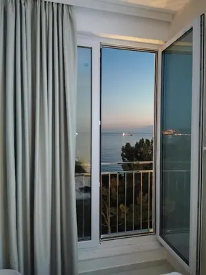 a room with a large window with a view of the ocean at Hotel MonteNino in Bar