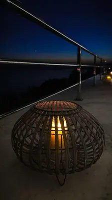 a light in a metal basket on a sidewalk at night at Hotel MonteNino in Bar