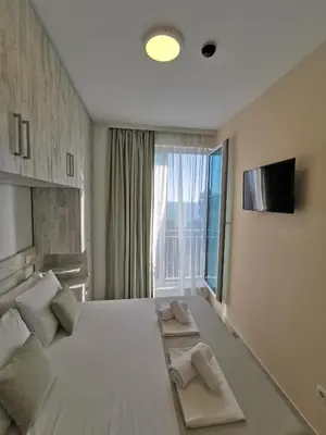 a bedroom with a large bed with a large window at Hotel MonteNino in Bar