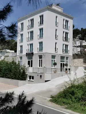 a large white building on the side of a road at Hotel MonteNino in Bar