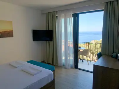 a hotel room with a view of a balcony at REZEVICI BOUTIQUE VILLA in Petrovac na Moru