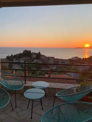 a patio with chairs and a view of the ocean at REZEVICI BOUTIQUE VILLA in Petrovac na Moru