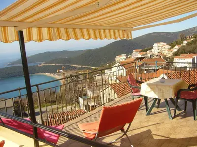 a balcony with chairs and a table and a view at MARINOVIC APARTMENTS in Budva