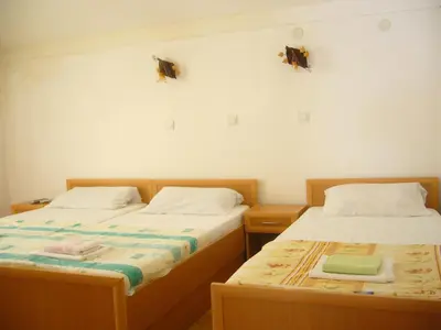 two beds sitting next to each other in a room at MARINOVIC APARTMENTS in Budva