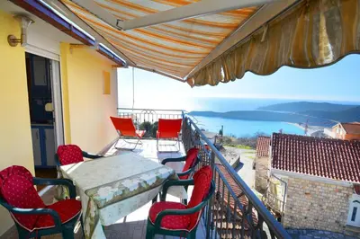a balcony with a table and chairs and a view at MARINOVIC APARTMENTS in Budva