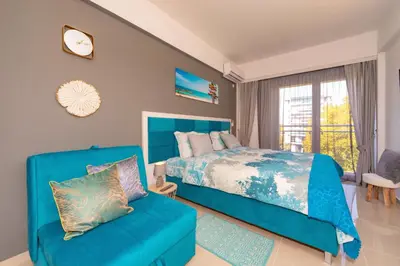 a bedroom with a blue bed and a couch at Sea&Center Lux in Bar