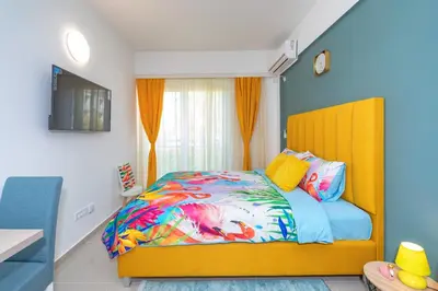 a bedroom with a bed with a colorful comforter at Sea&Center Lux in Bar