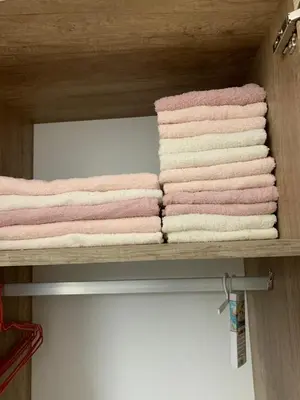 a group of towels are stacked on a shelf at Sea&Center Lux in Bar