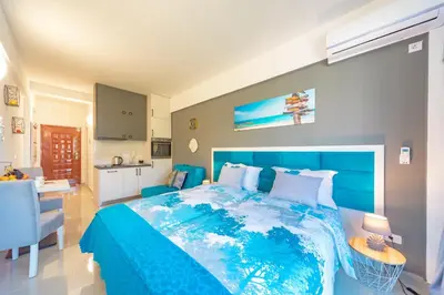 a bedroom with a blue bed and a kitchen at Sea&Center Lux in Bar