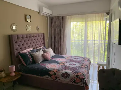 a bedroom with a bed with a large window at Sea&Center Lux in Bar